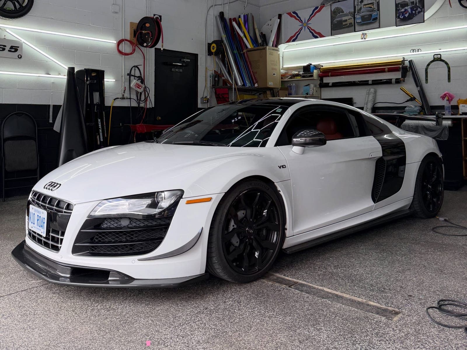 White Audi R8 with a gloss black wrapped roof and carbon side blades
