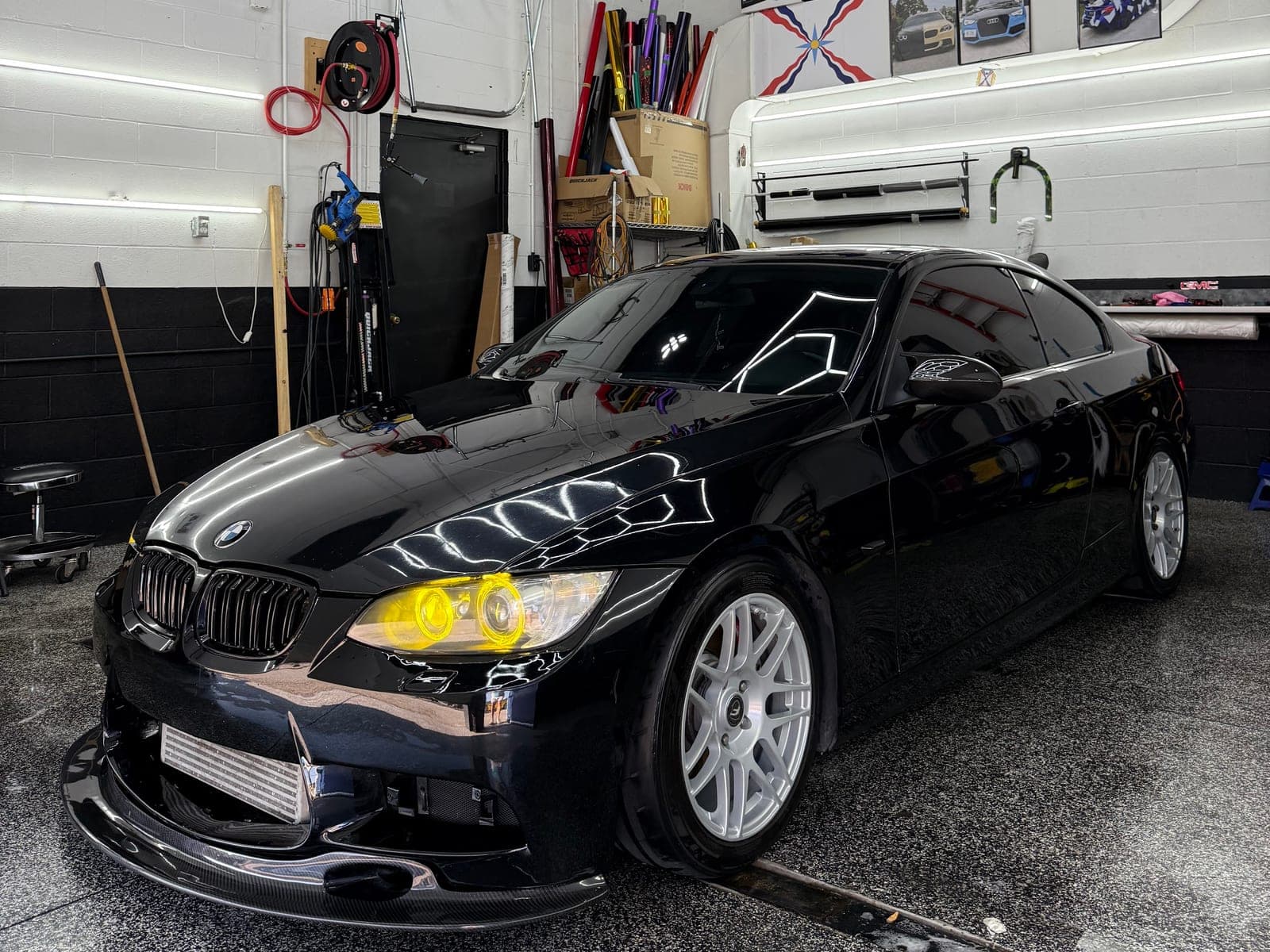 Black BMW E92 coupe with yellow tinted headlights