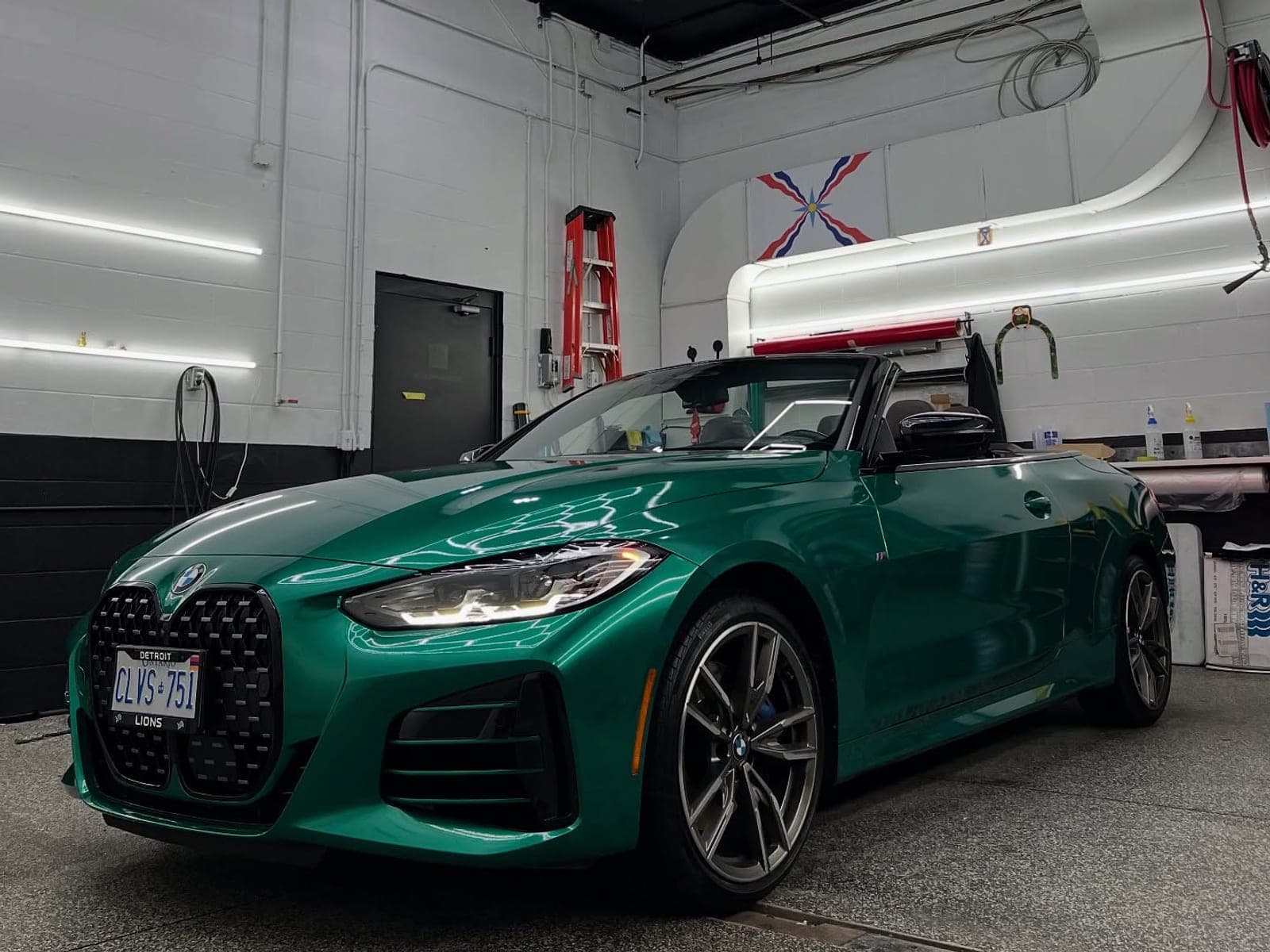 BMW M440i convertible in gloss dark green pearl inside the shop