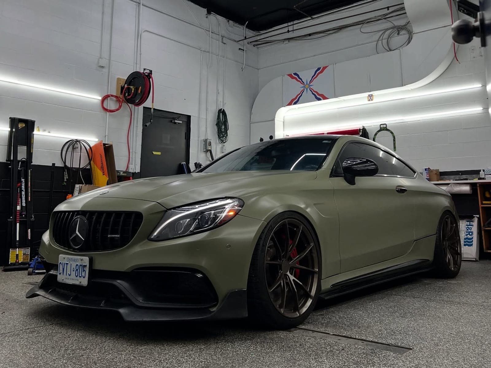 Mercedes-AMG C63 coupe wrapped in khaki green with bronze wheels