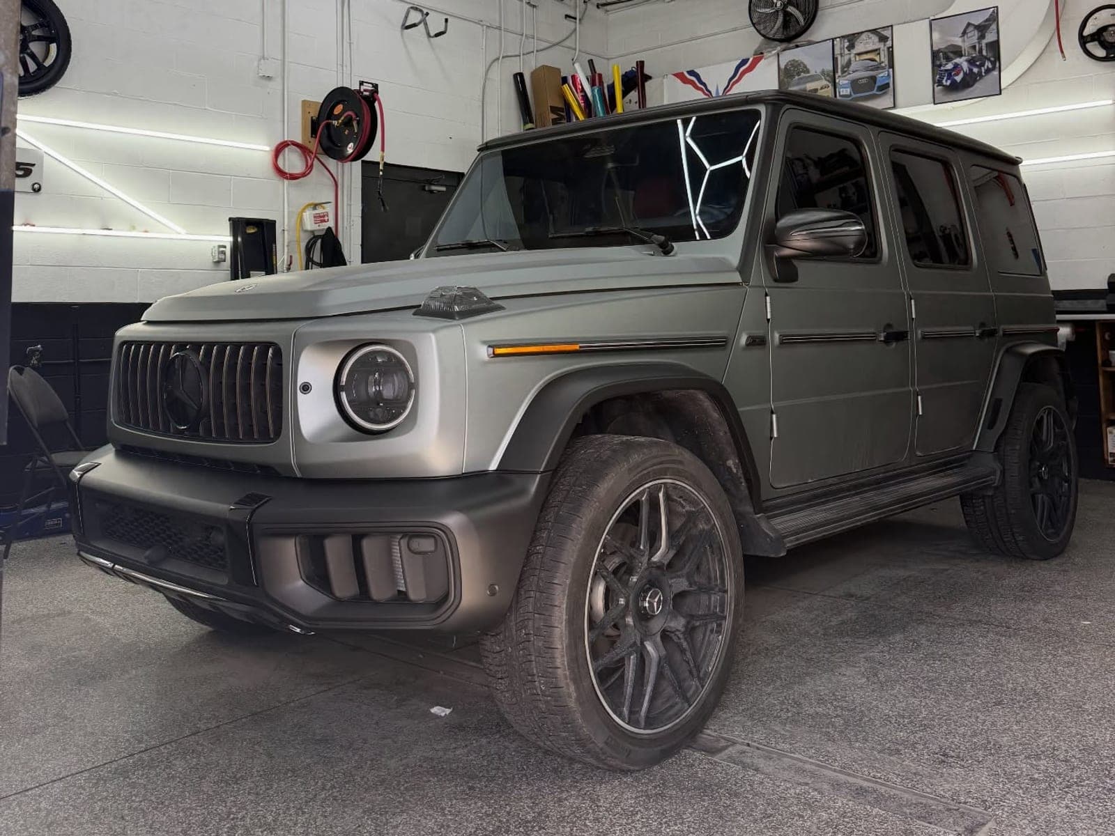 Grey Mercedes G-Wagon with bumpers, roof and flares wrapped in matte metallic black