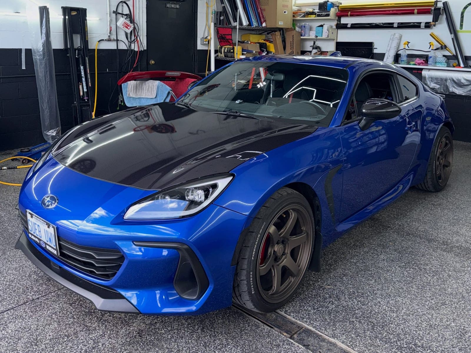 Blue Subaru BRZ with a carbon fibre wrapped hood