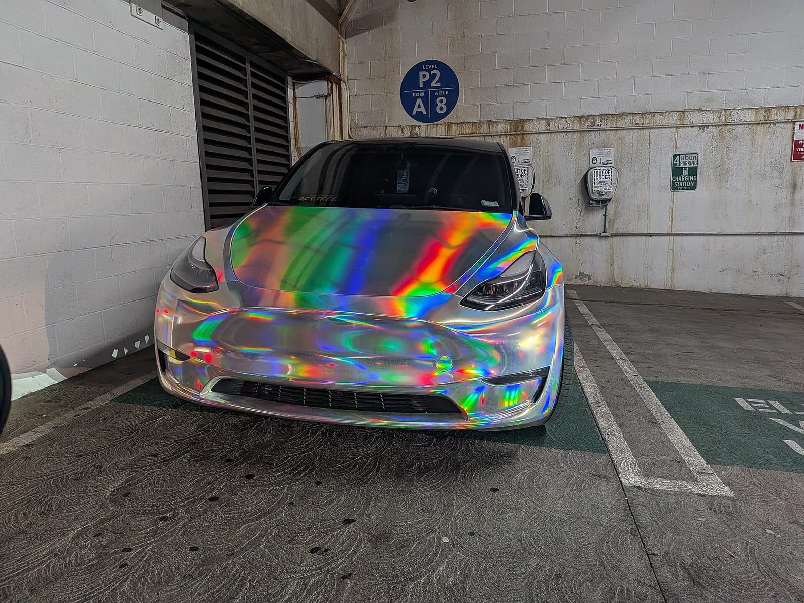 Tesla Model 3 in rainbow holographic chrome wrap