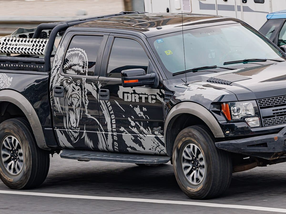 Black Ford Raptor pickup with custom printed side graphics